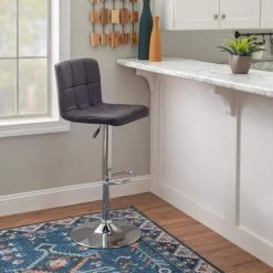 Chad 35.6 in. H - 44 in. H Chocolate Faux Leather Chrome Adjustable Barstool with Faux Leather Seat by Powell Company -Powell Company Shop chocolate brown powell company bar stools hd1672bs21 31 1000